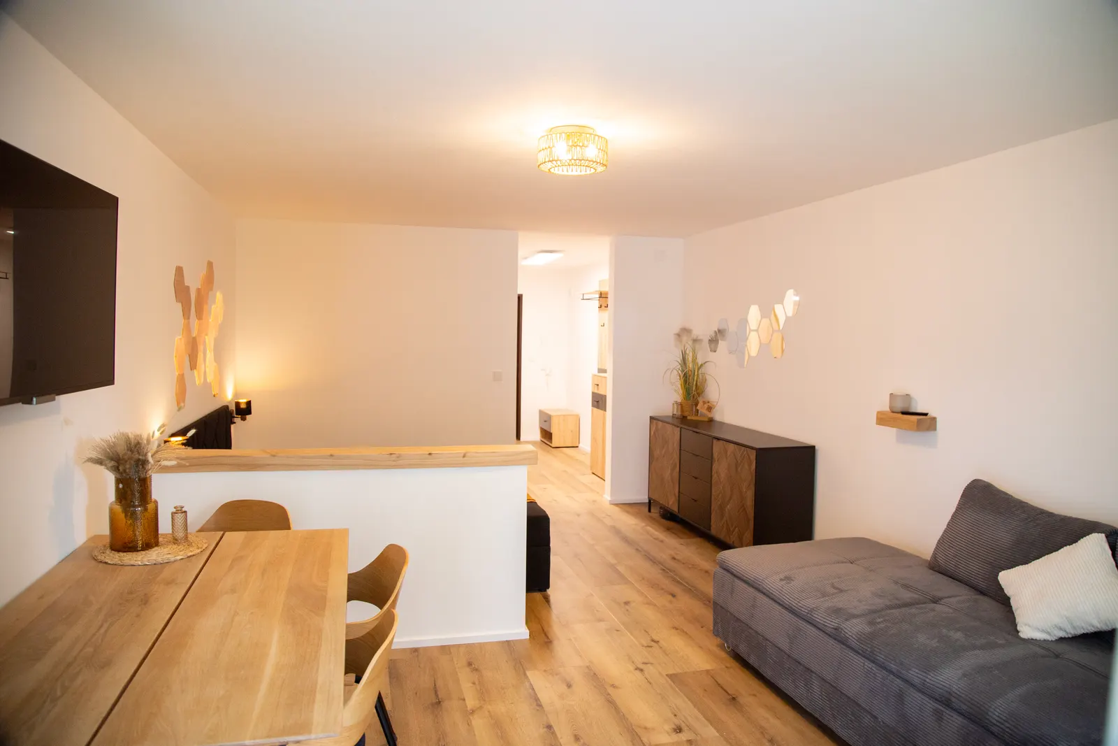 Open-plan living area with dining table and sofa