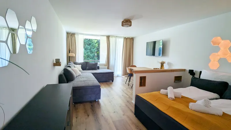View across the double bed into the living area