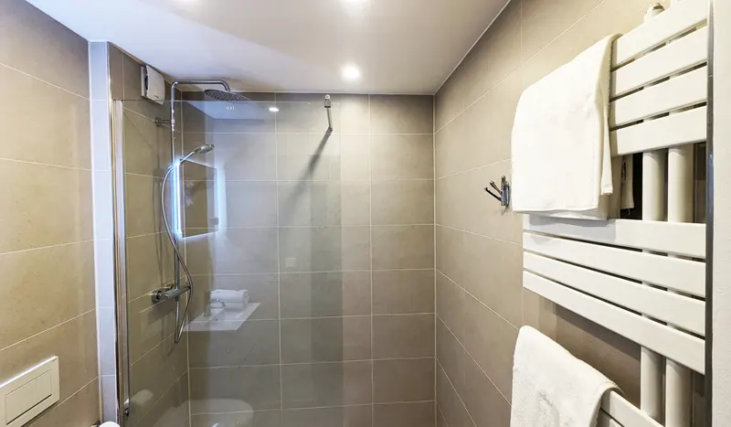 Shower with heated towel rail