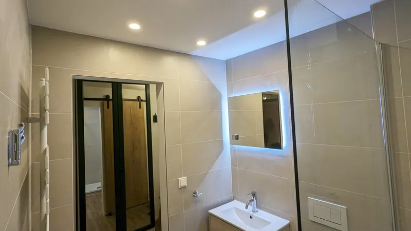Bathroom with illuminated mirror